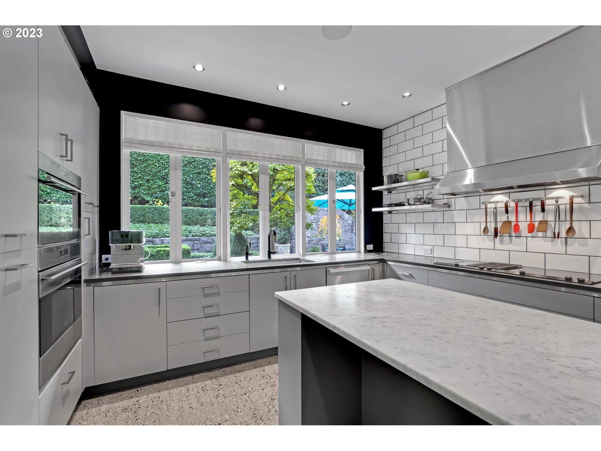 2122 Southwest Myrtle Street Portland, OR 97201 - Photo 27 of 47 a open kitchen with stainless steel appliances granite countertop a sink and large window