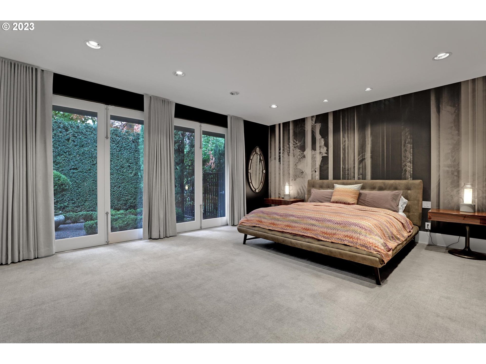 2122 Southwest Myrtle Street Portland, OR 97201 - Photo 34 of 47 a bedroom with a large bed and large windows