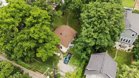an aerial view of a house with garden space and street view