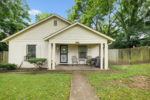 a front view of house with a garden and patio