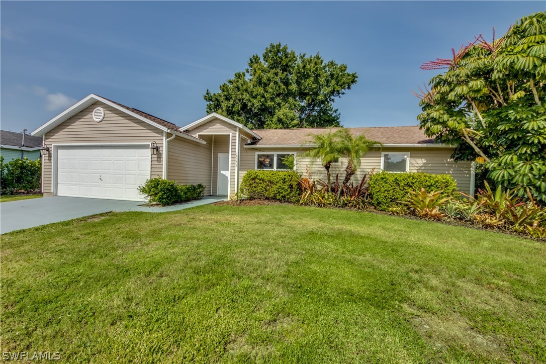 18372 Hawthorne Road Fort Myers, FL 33967 - Photo 1 of 28 a front view of a house with garden