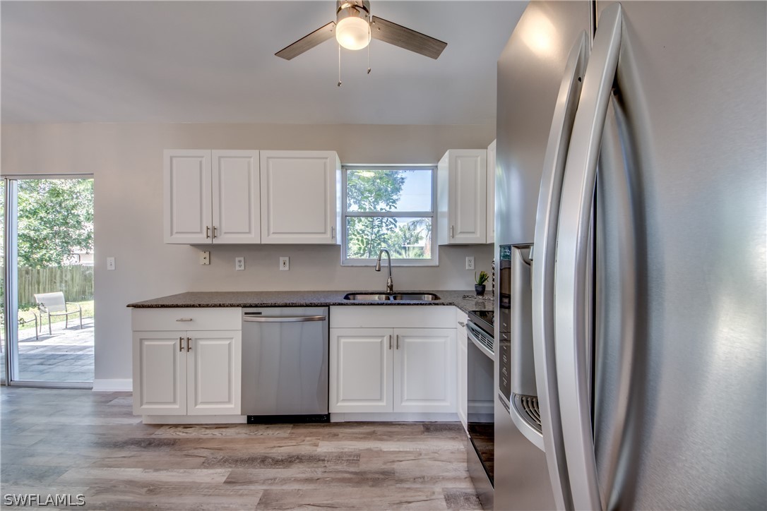 18372 Hawthorne Road Fort Myers, FL 33967 - Photo 6 of 28 a kitchen with stainless steel appliances granite countertop a refrigerator and a sink