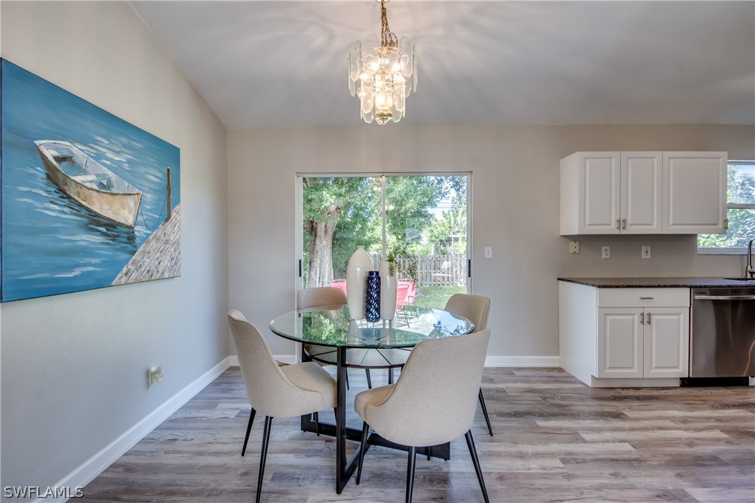 18372 Hawthorne Road Fort Myers, FL 33967 - Photo 10 of 28 a dining room with furniture a window and wooden floor