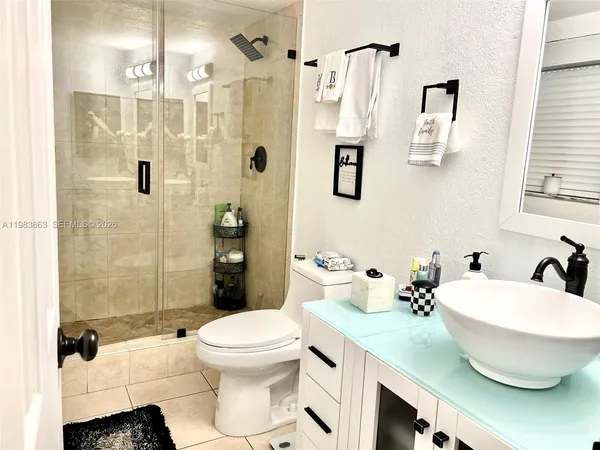 a bathroom with a toilet sink and shower