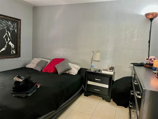 a bedroom with a bed and a dresser