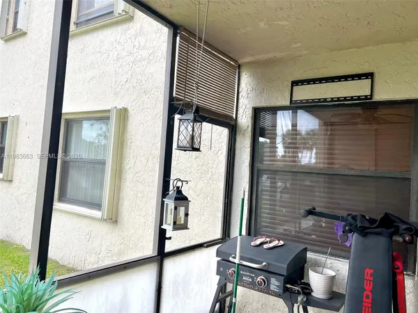 a view of a hallway with workspace and living room