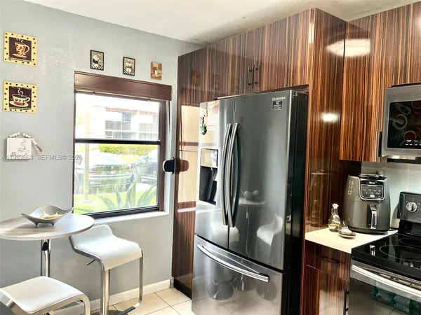 a kitchen with stainless steel appliances a refrigerator and a counter space