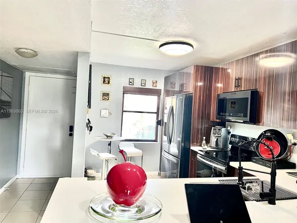 a kitchen with stainless steel appliances granite countertop a refrigerator stove top oven and sink