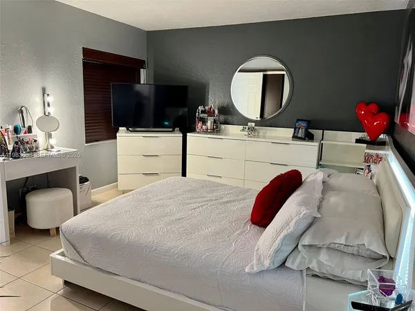 a bedroom with a bed and a mirror