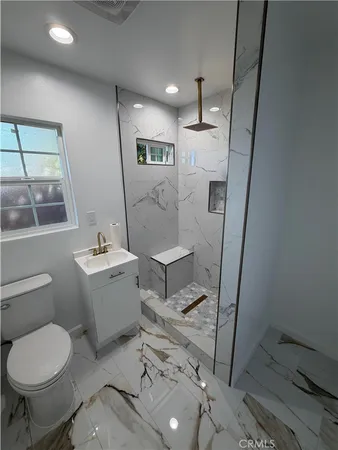 a bathroom with a sink toilet and a mirror