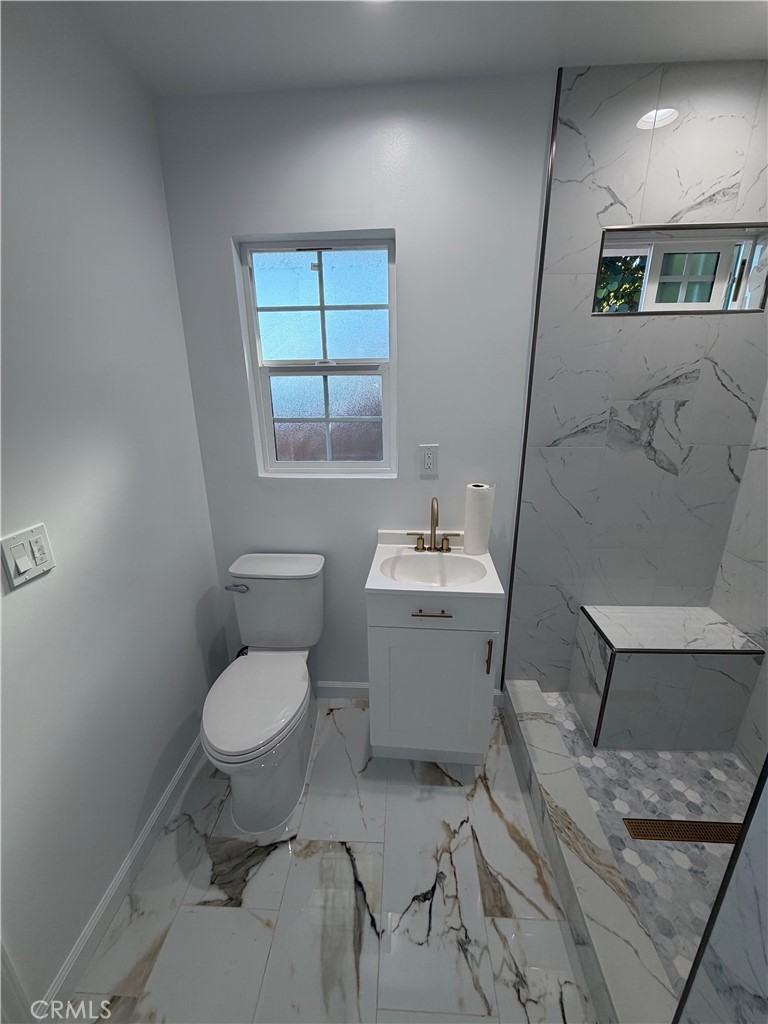 7476 Brookside Road Rancho Cucamonga, CA 91730 - Photo 13 of 13 a bathroom with a sink toilet and a mirror