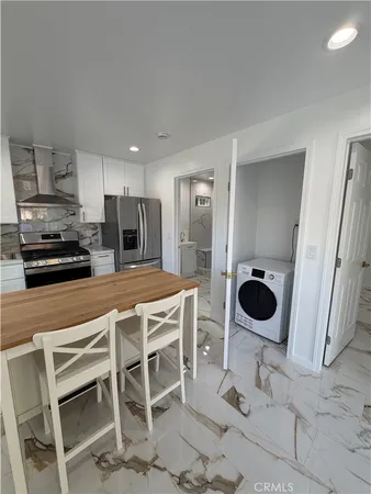 a kitchen with a dining table and chairs
