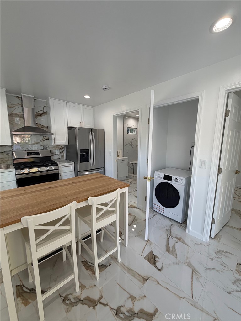 7476 Brookside Road Rancho Cucamonga, CA 91730 - Photo 8 of 13 a kitchen with a dining table and chairs