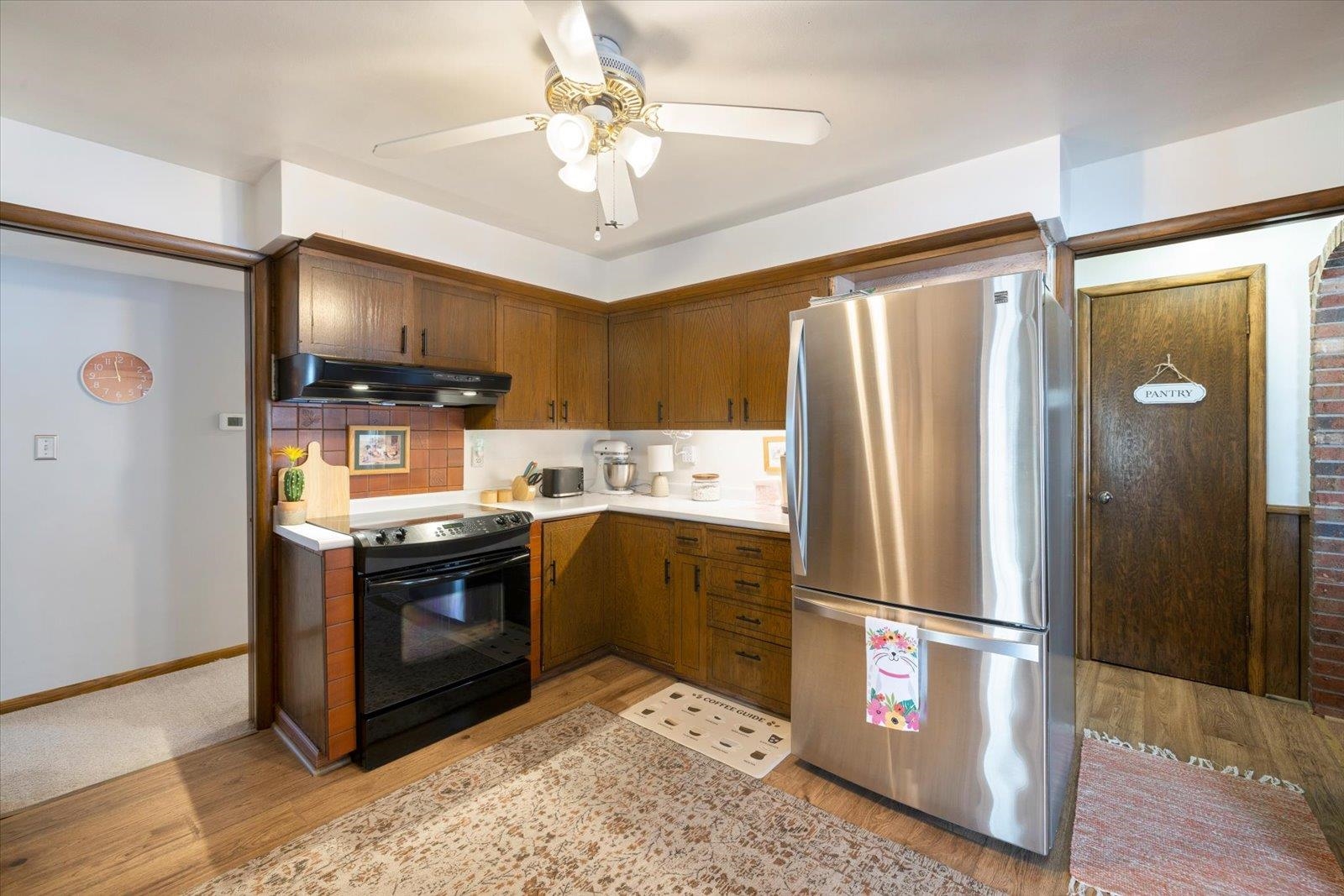 502 North Inner Drive Hibbing, MN 55746 - Photo 17 of 57 Kitchen with freestanding refrigerator, light countertops, electric range, a ceiling fan, and light wood-style flooring