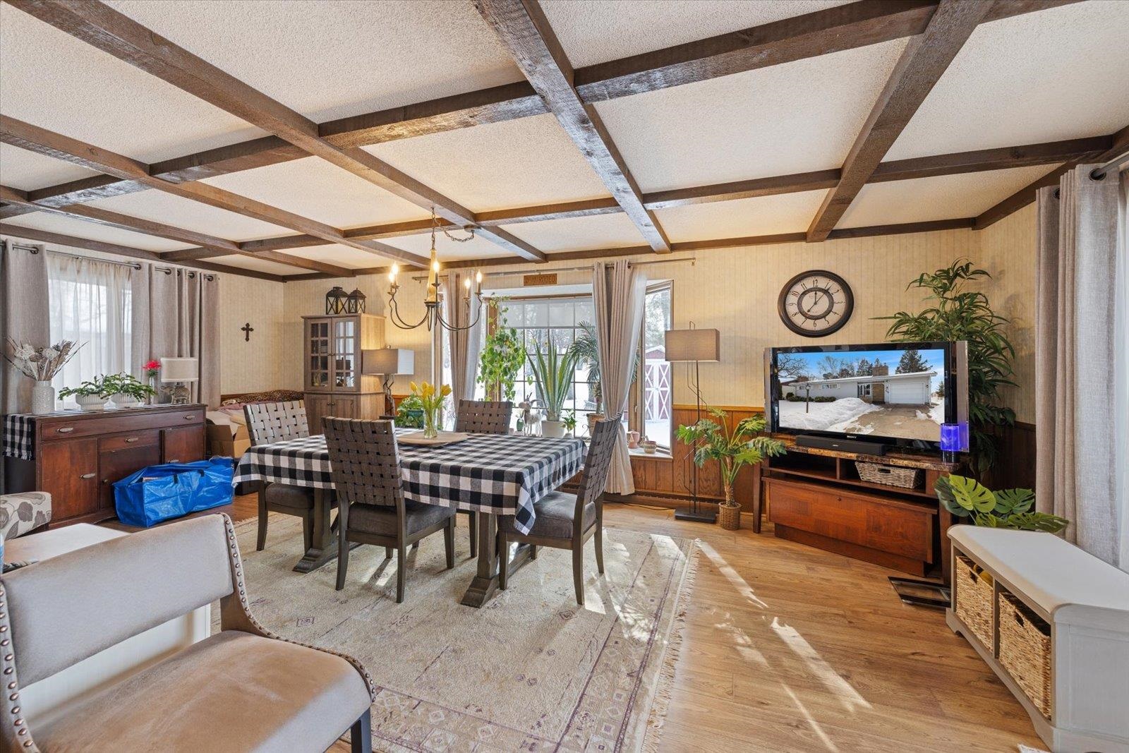 502 North Inner Drive Hibbing, MN 55746 - Photo 18 of 57 Dining space featuring coffered ceiling, a wainscoted wall, light wood finished floors, hanging lights, and wallpapered walls