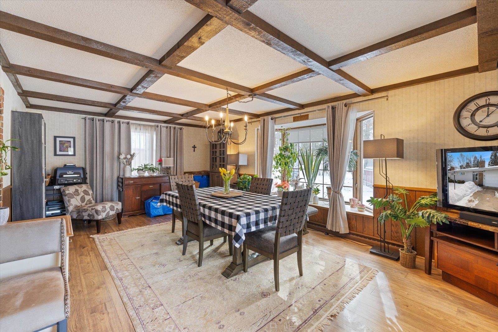 502 North Inner Drive Hibbing, MN 55746 - Photo 20 of 57 Dining room featuring coffered ceiling, wainscoting, wallpapered walls, light wood finished floors, and a chandelier
