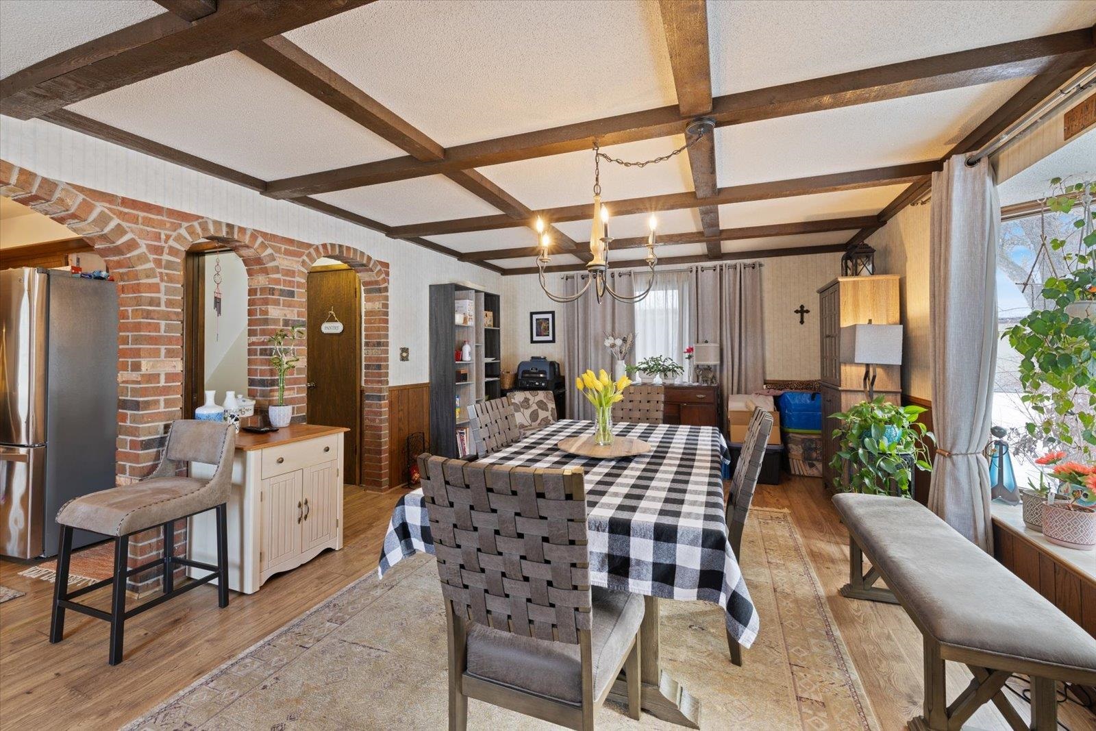 502 North Inner Drive Hibbing, MN 55746 - Photo 21 of 57 Dining room featuring wainscoting, suspended lighting, light wood-style floors, coffered ceiling, and wood walls