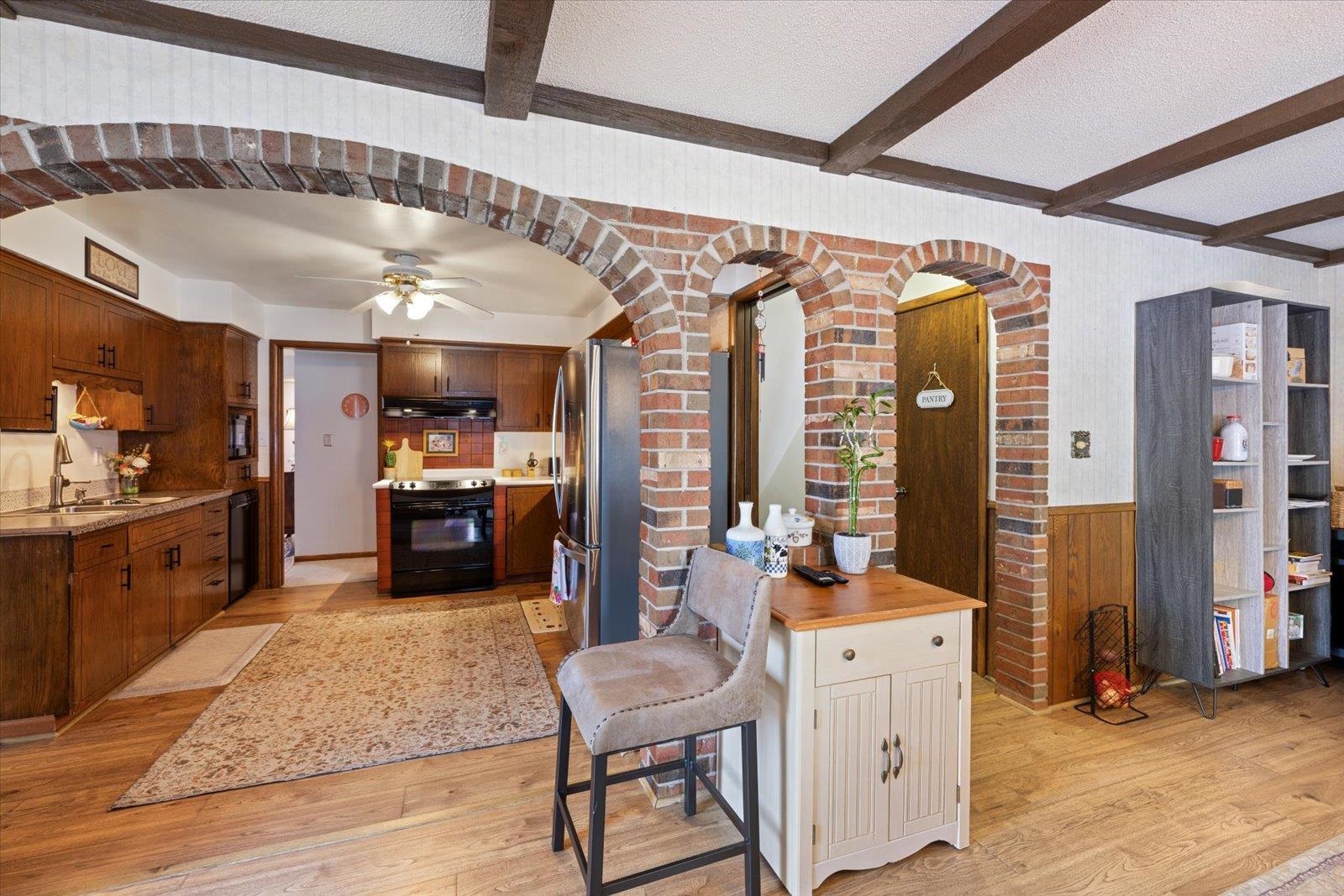 502 North Inner Drive Hibbing, MN 55746 - Photo 24 of 57 Kitchen with a textured ceiling, black appliances, wainscoting, arched walkways, and ceiling fan