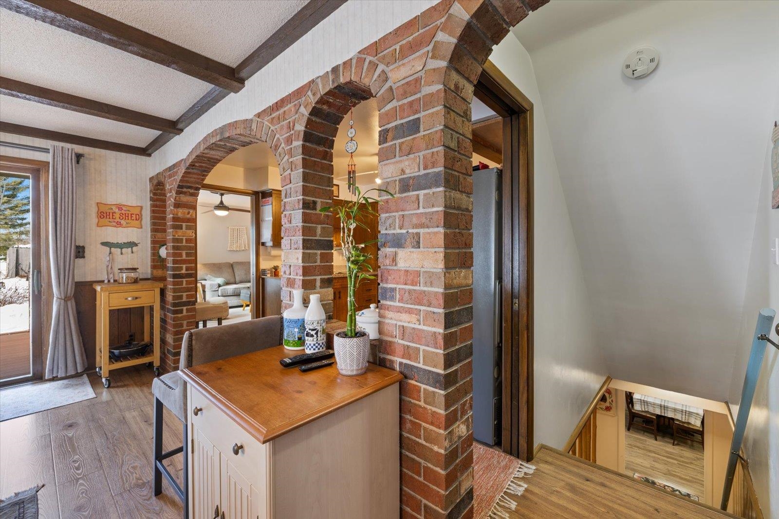 502 North Inner Drive Hibbing, MN 55746 - Photo 25 of 57 Kitchen featuring arched walkways, a textured ceiling, beam ceiling, wood finished floors, and wooden counters