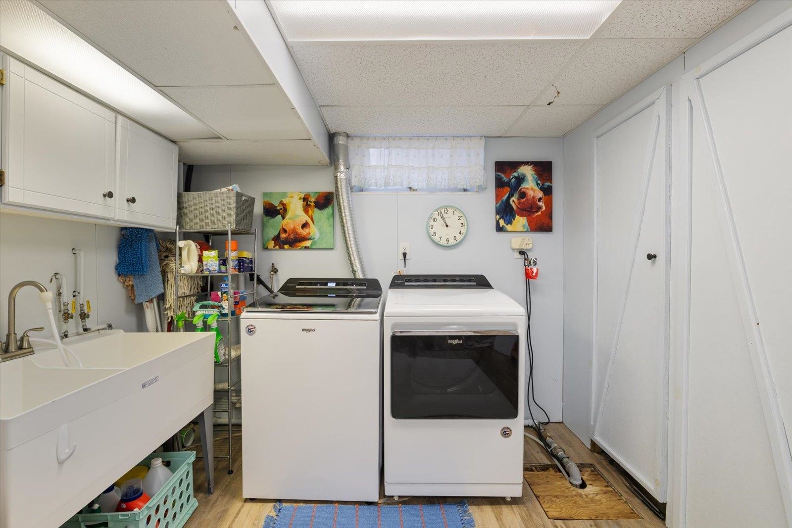 502 North Inner Drive Hibbing, MN 55746 - Photo 50 of 57 Laundry room featuring a drop ceiling, washer and clothes dryer, light wood-style flooring, and cabinet space