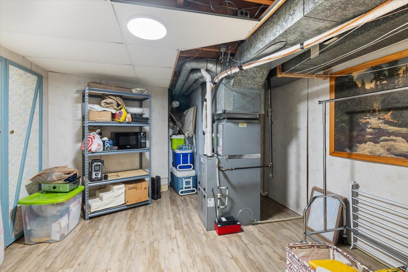 502 North Inner Drive Hibbing, MN 55746 - Photo 54 of 57 Unfinished below grade area with light wood finished floors, heating unit, and a paneled ceiling