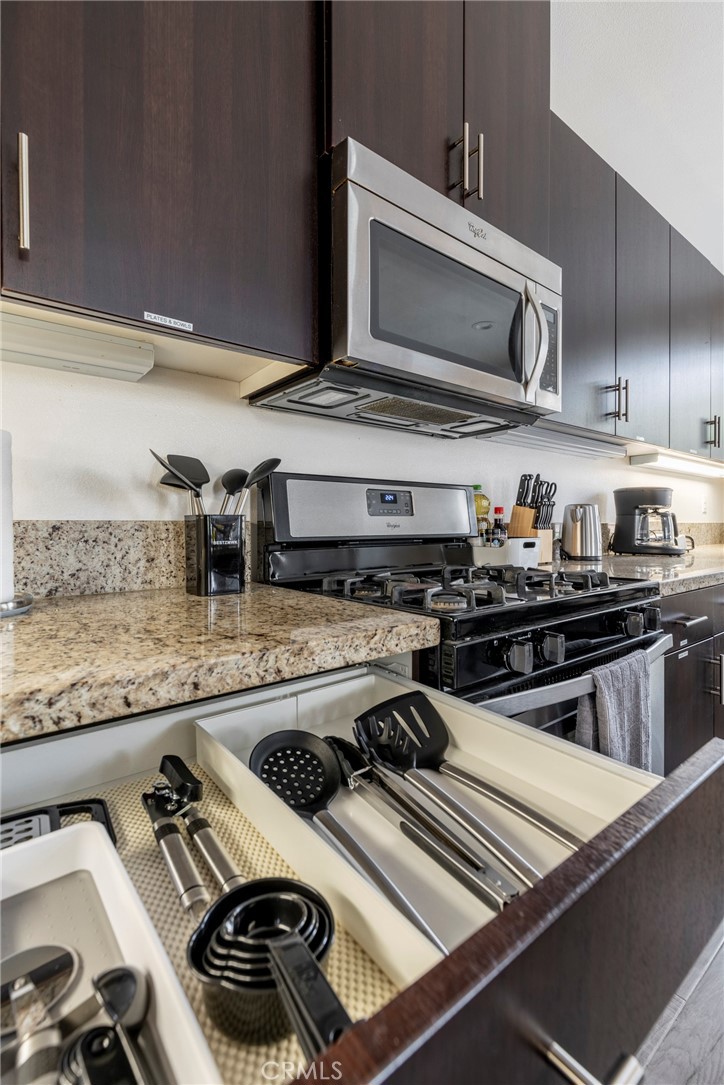 816 East Promenade, Unit A Azusa, CA 91702 - Photo 16 of 75 a close view of a stove and a sink with wooden cabinets