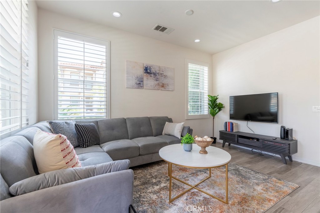 816 East Promenade, Unit A Azusa, CA 91702 - Photo 24 of 75 a living room with furniture and a flat screen tv