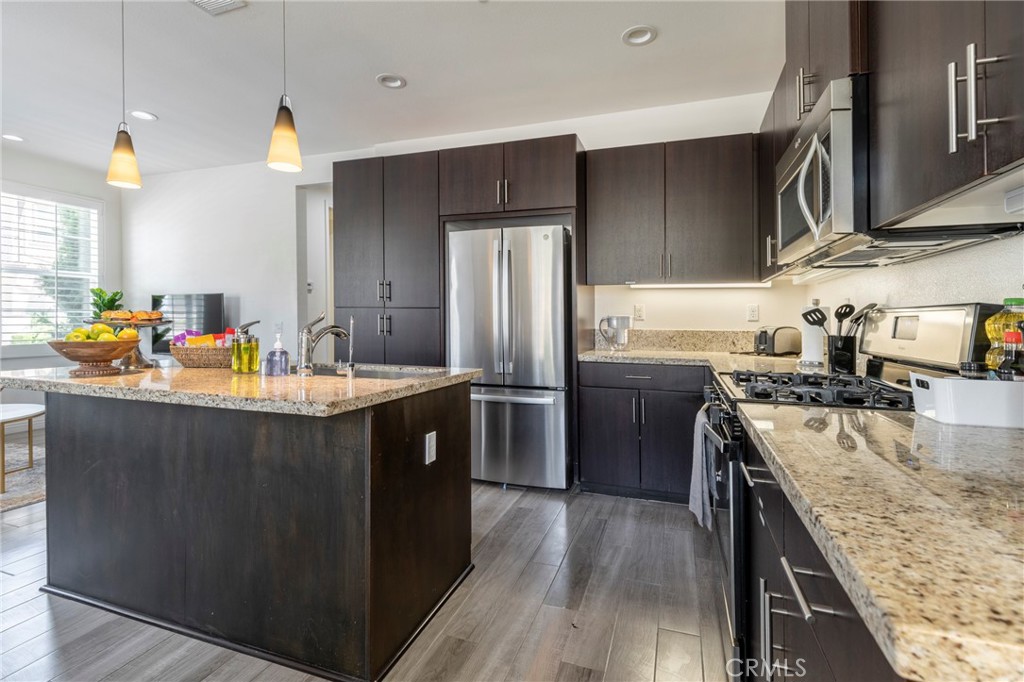 816 East Promenade, Unit A Azusa, CA 91702 - Photo 25 of 75 a kitchen with stainless steel appliances granite countertop a sink stove and refrigerator