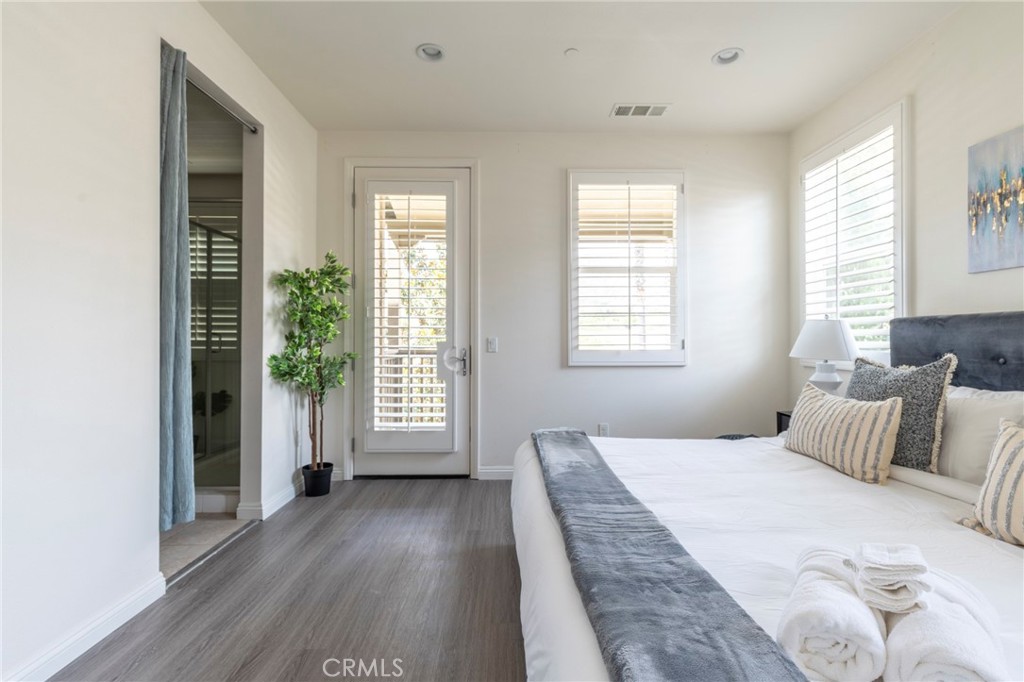 816 East Promenade, Unit A Azusa, CA 91702 - Photo 30 of 75 a bedroom with a bed and a large window