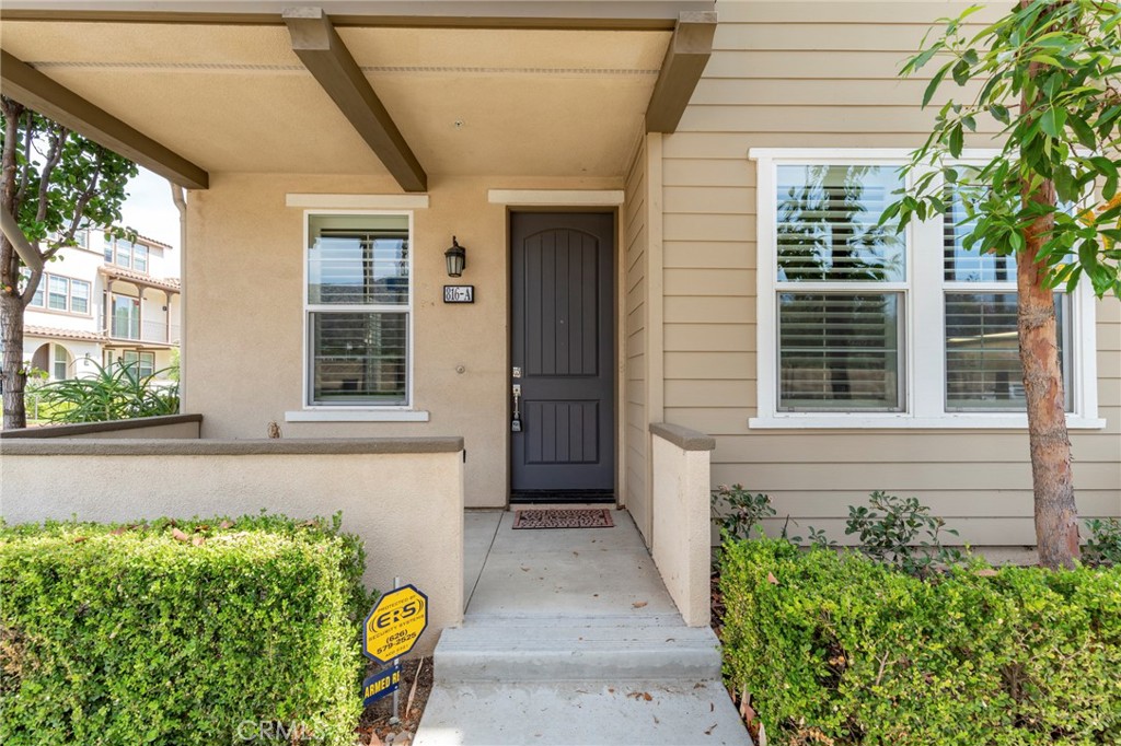 816 East Promenade, Unit A Azusa, CA 91702 - Photo 3 of 75 a front view of a house with a garden