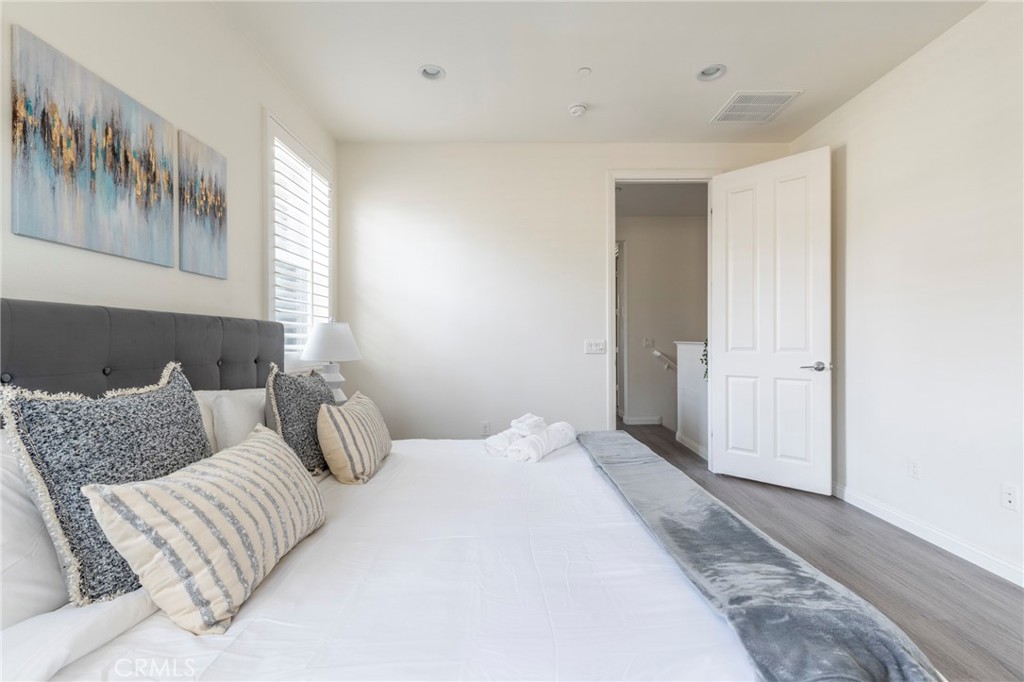 816 East Promenade, Unit A Azusa, CA 91702 - Photo 32 of 75 a bedroom with a bed and a couch