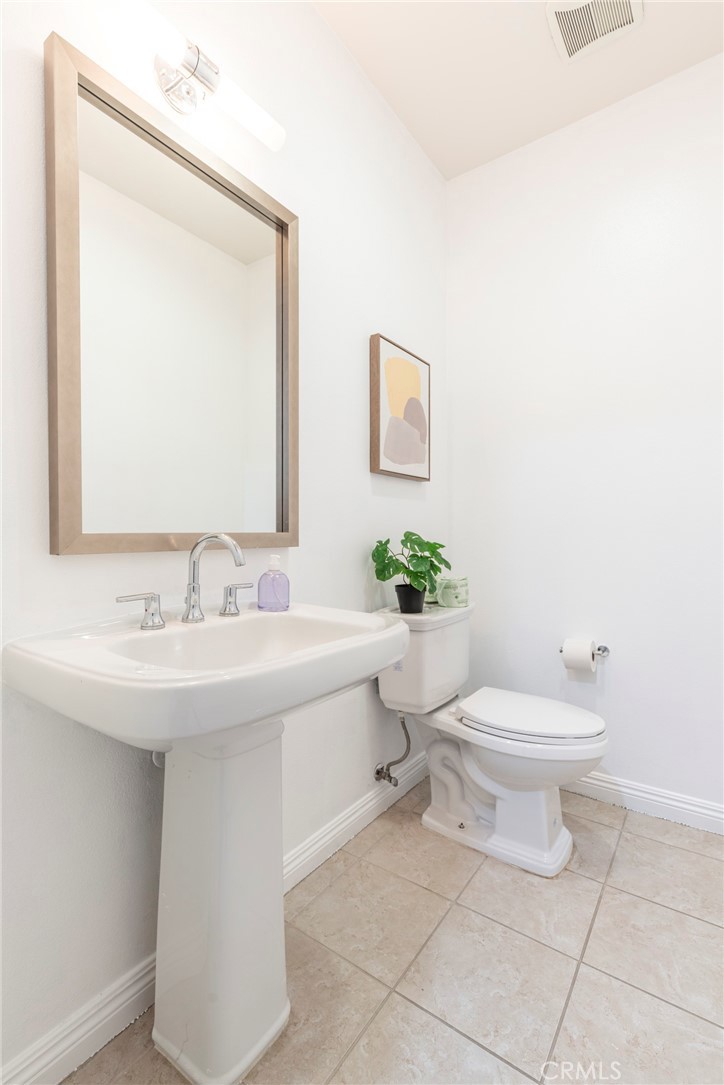 816 East Promenade, Unit A Azusa, CA 91702 - Photo 34 of 75 a bathroom with a toilet sink and mirror