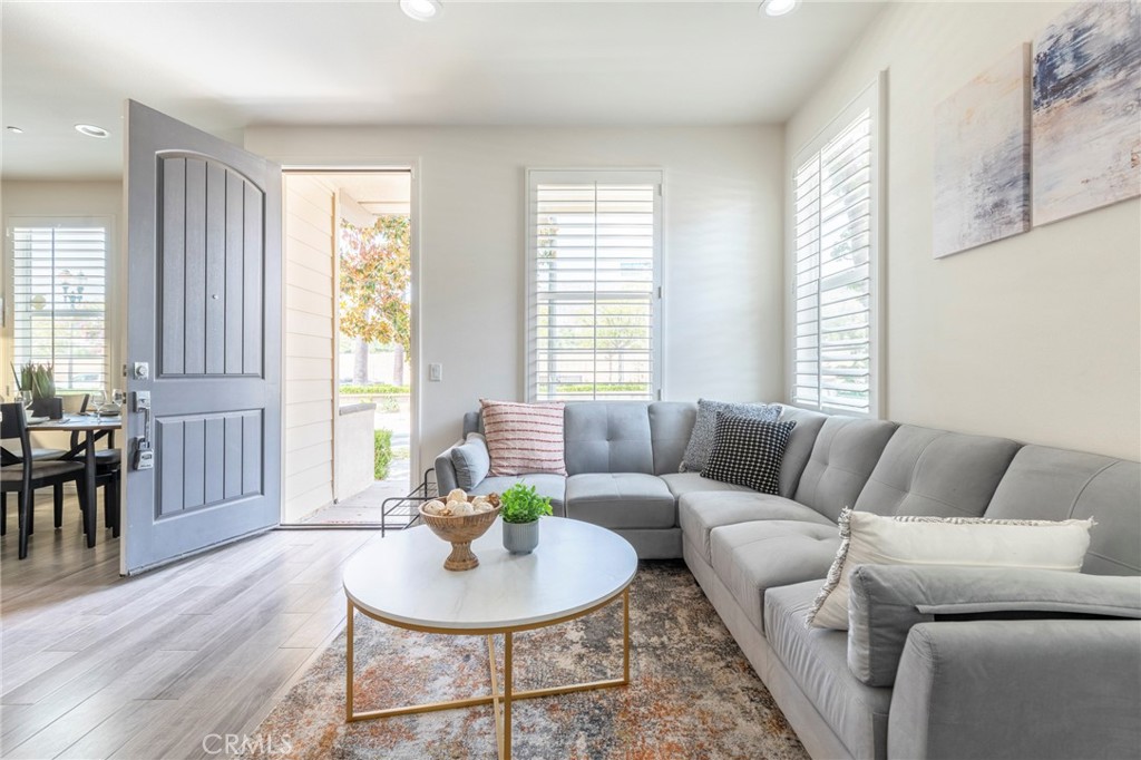 816 East Promenade, Unit A Azusa, CA 91702 - Photo 38 of 75 a living room with furniture and a wooden floor