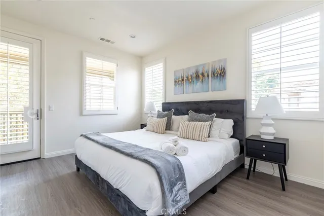 a bed sitting in a bedroom and painting on the wall