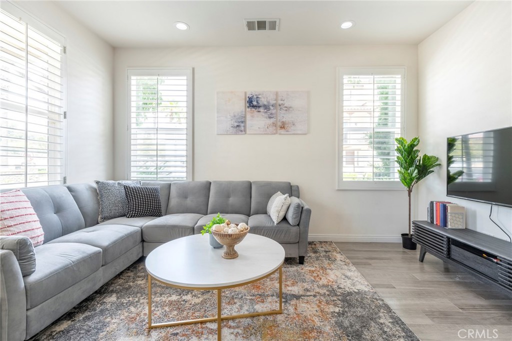 816 East Promenade, Unit A Azusa, CA 91702 - Photo 41 of 75 a living room with furniture and a potted plant
