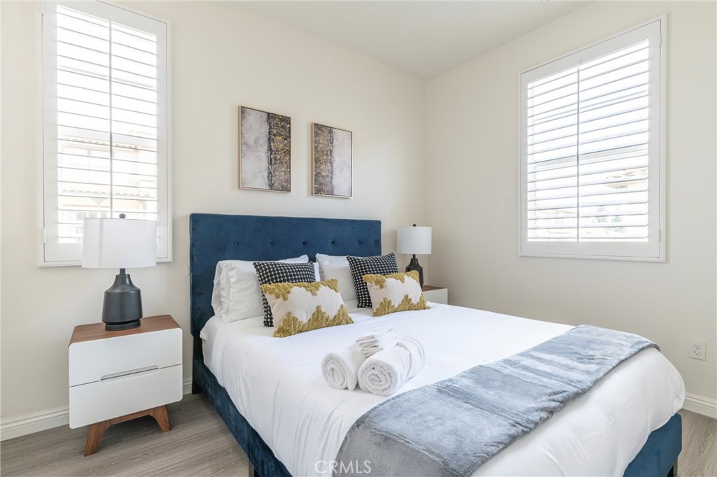 816 East Promenade, Unit A Azusa, CA 91702 - Photo 56 of 75 a bedroom with a large bed and a couch