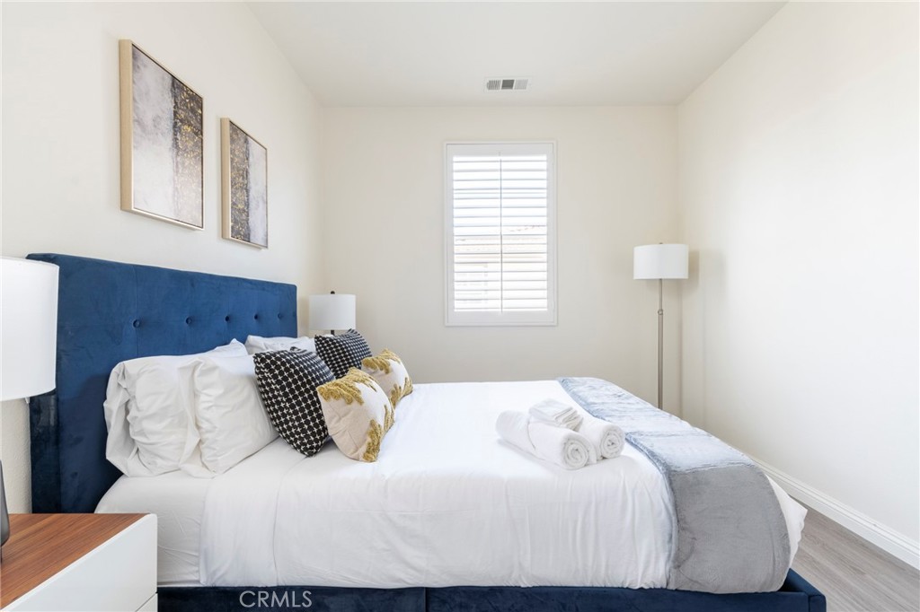 816 East Promenade, Unit A Azusa, CA 91702 - Photo 57 of 75 a bedroom with a bed and wooden floor