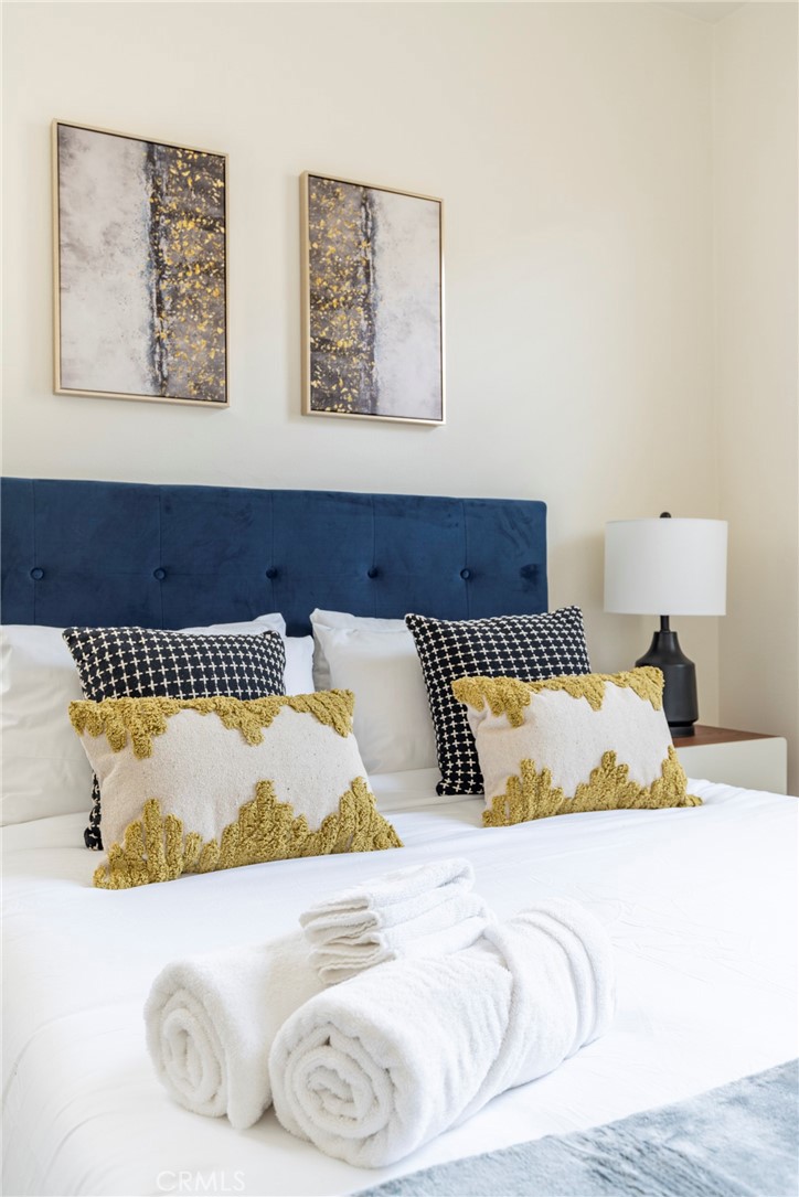 816 East Promenade, Unit A Azusa, CA 91702 - Photo 61 of 75 a bed sitting in a bedroom and painting on the wall