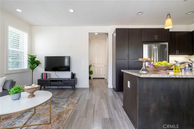 a kitchen with granite countertop a sink stove and refrigerator