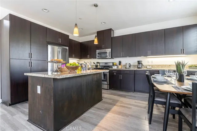 a kitchen with a stove a sink and cabinets