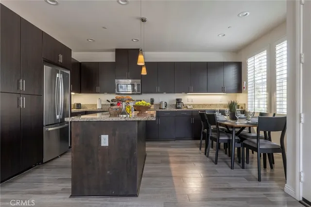 a kitchen with granite countertop wooden cabinets and a stove top oven