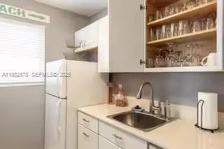 a kitchen with appliances a sink and cabinets