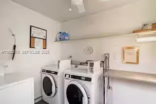 a view of a storage & utility room with a washer dryer