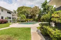 a view of yard with swimming pool and green space