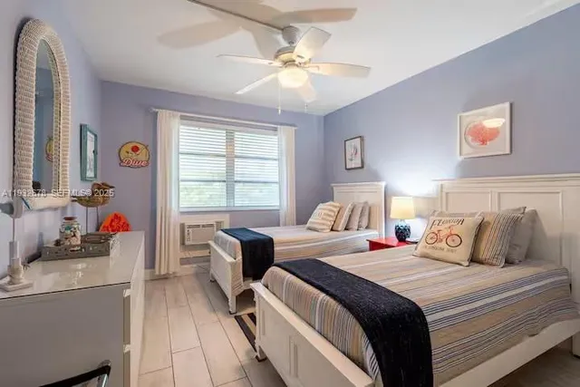 a bedroom with bed and a chandelier