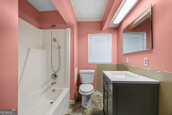 a bathroom with a sink a toilet and a mirror