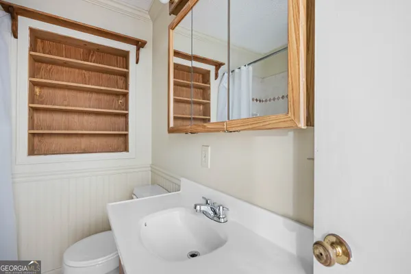 a white toilet sitting next to a bathroom sink