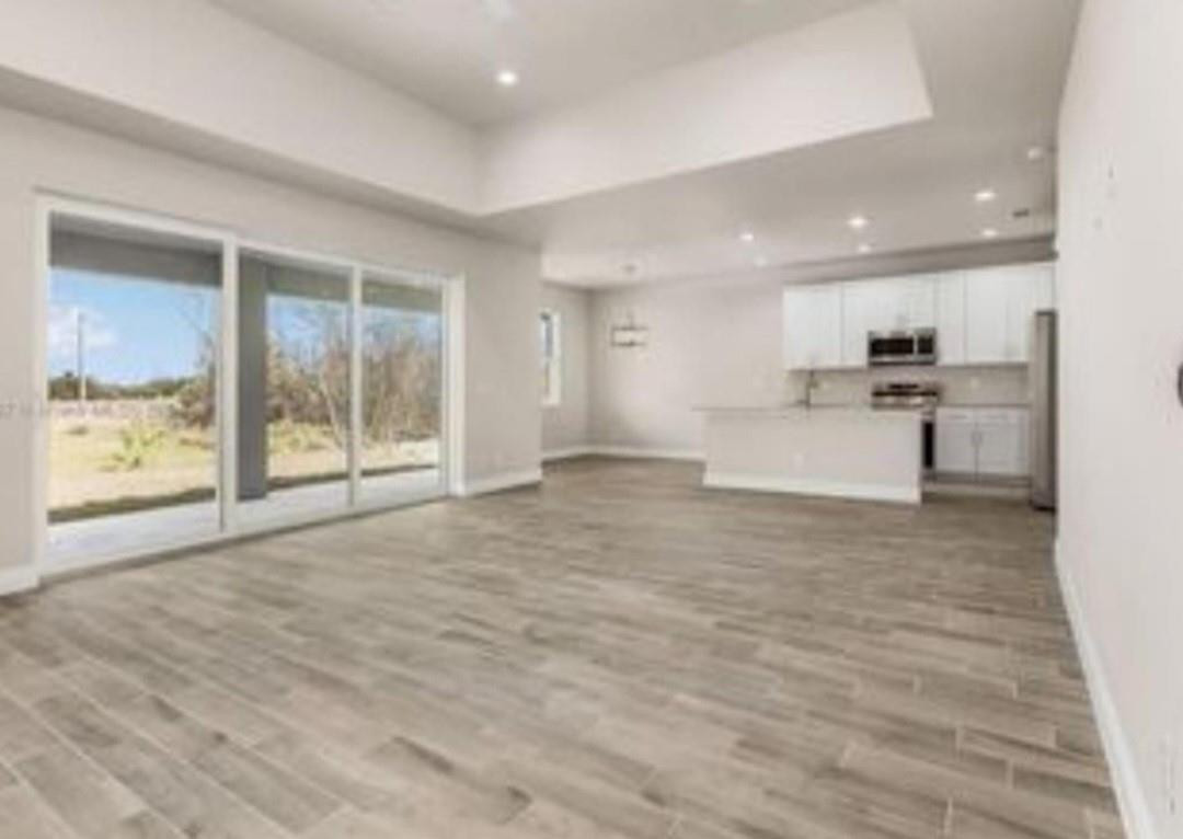 321 Neighborly Road LaBelle, FL 33935 - Photo 6 of 18 a view of large kitchen with granite countertop cabinets and refrigerator