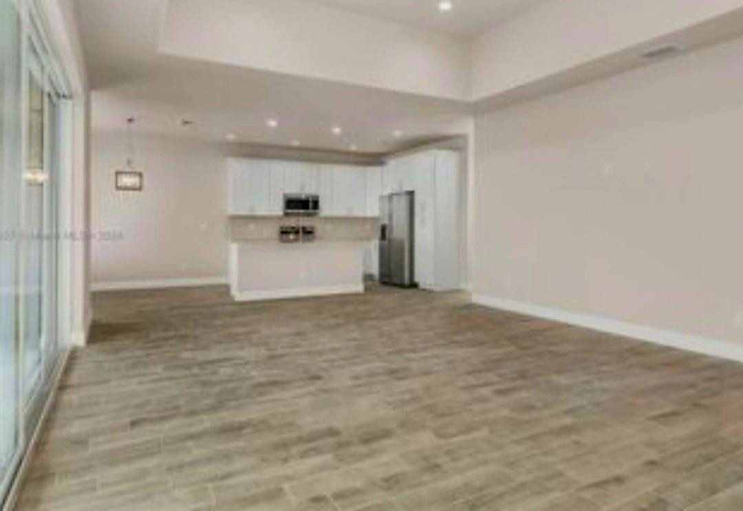 321 Neighborly Road LaBelle, FL 33935 - Photo 7 of 18 a view of a kitchen with a sink and a refrigerator