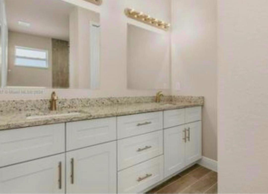 321 Neighborly Road LaBelle, FL 33935 - Photo 9 of 18 a bathroom with a granite countertop sink and vanity